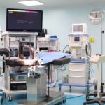 an operating room with anesthesia equipment and a surgical table