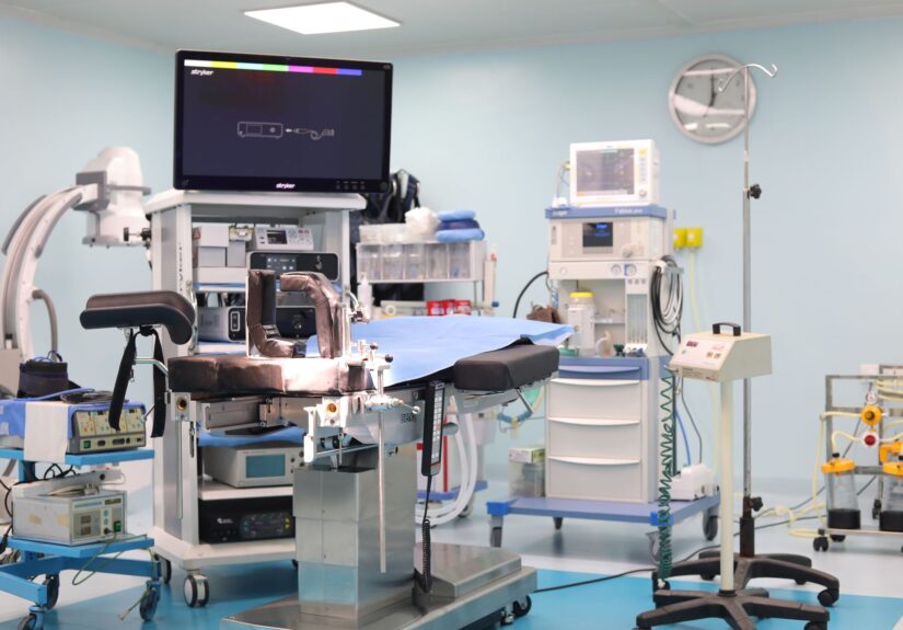 an operating room with anesthesia equipment and a surgical table